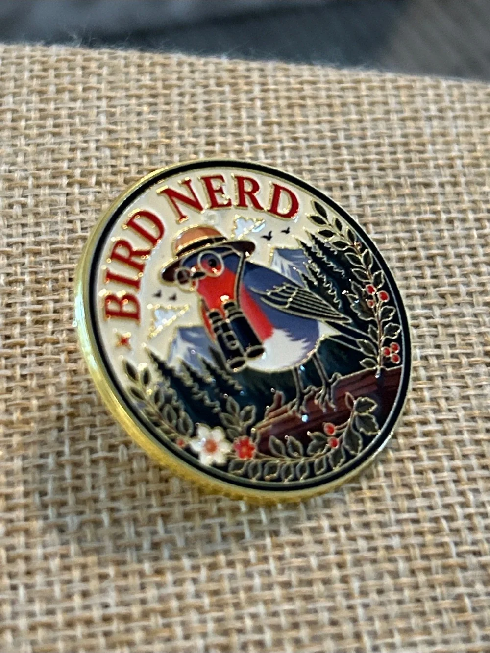 Bird Nerd Enamel Pin - Robin wearing binoculars in a garden forest scene